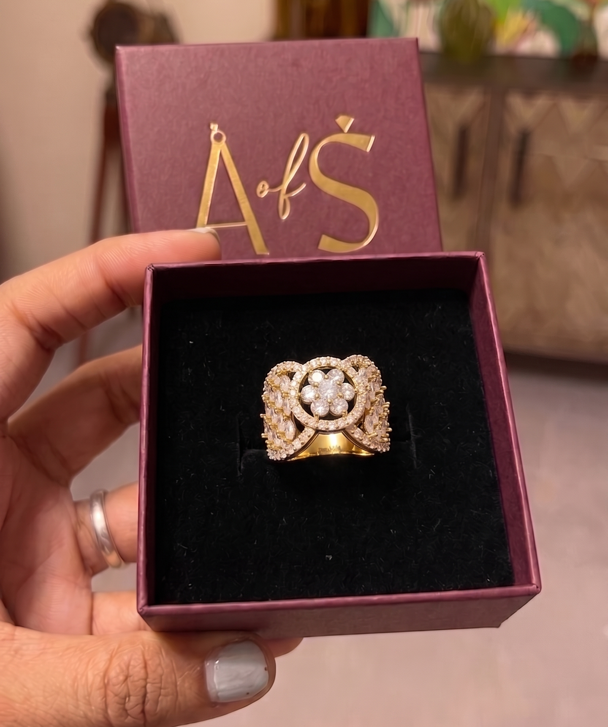 A wide yellow gold plated ring featuring