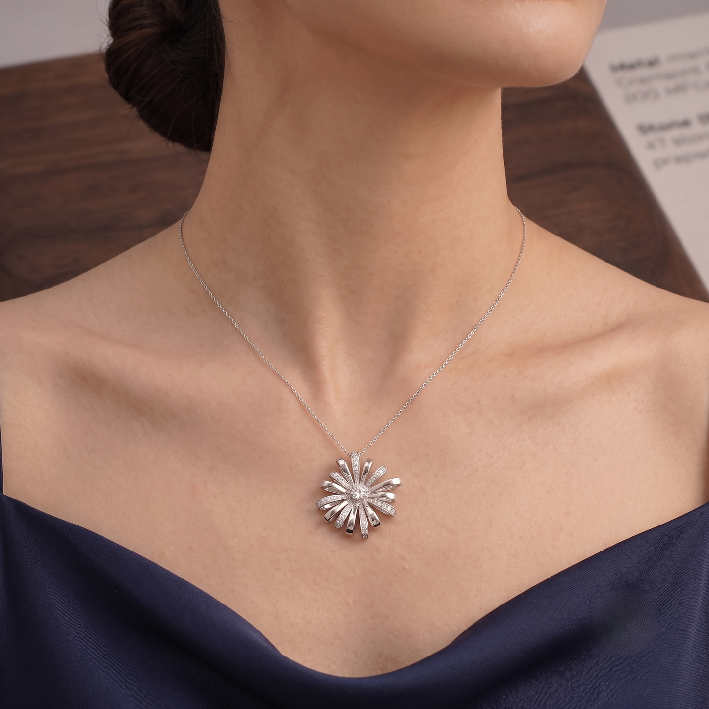 A silver sunburst chain pendant