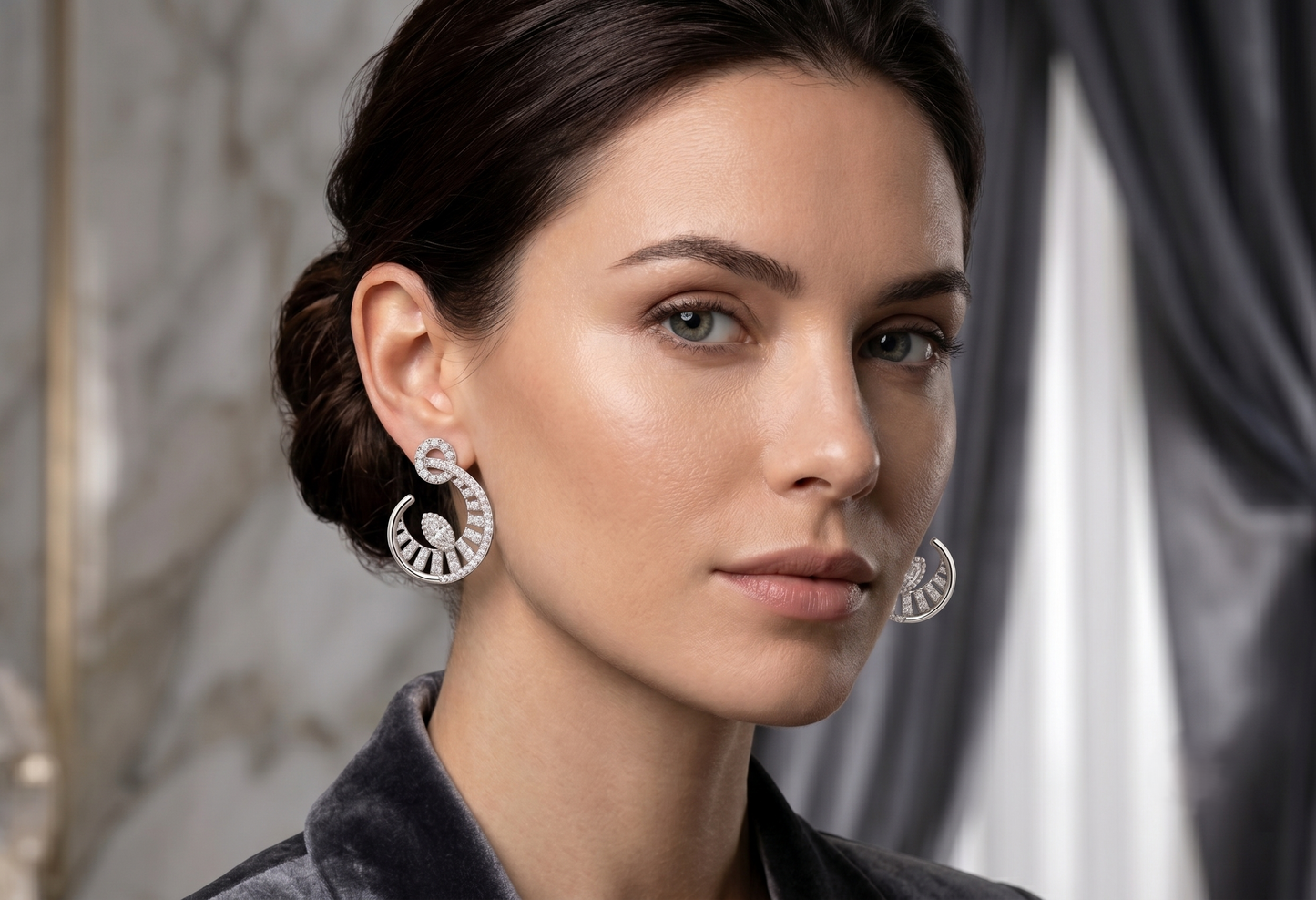 A pair of silver-toned crescent-shaped hoop earrings