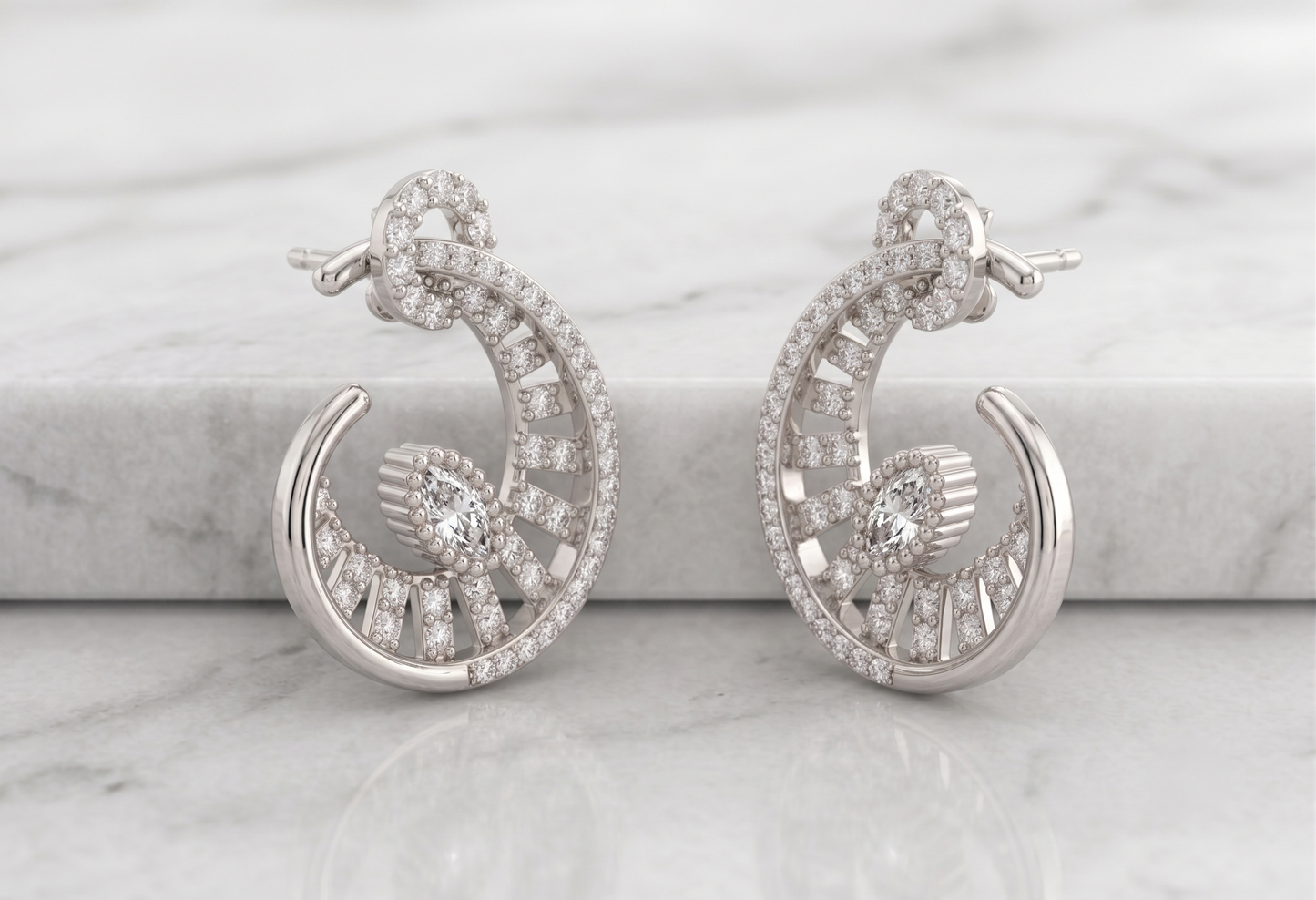 A pair of silver-toned crescent-shaped hoop earrings