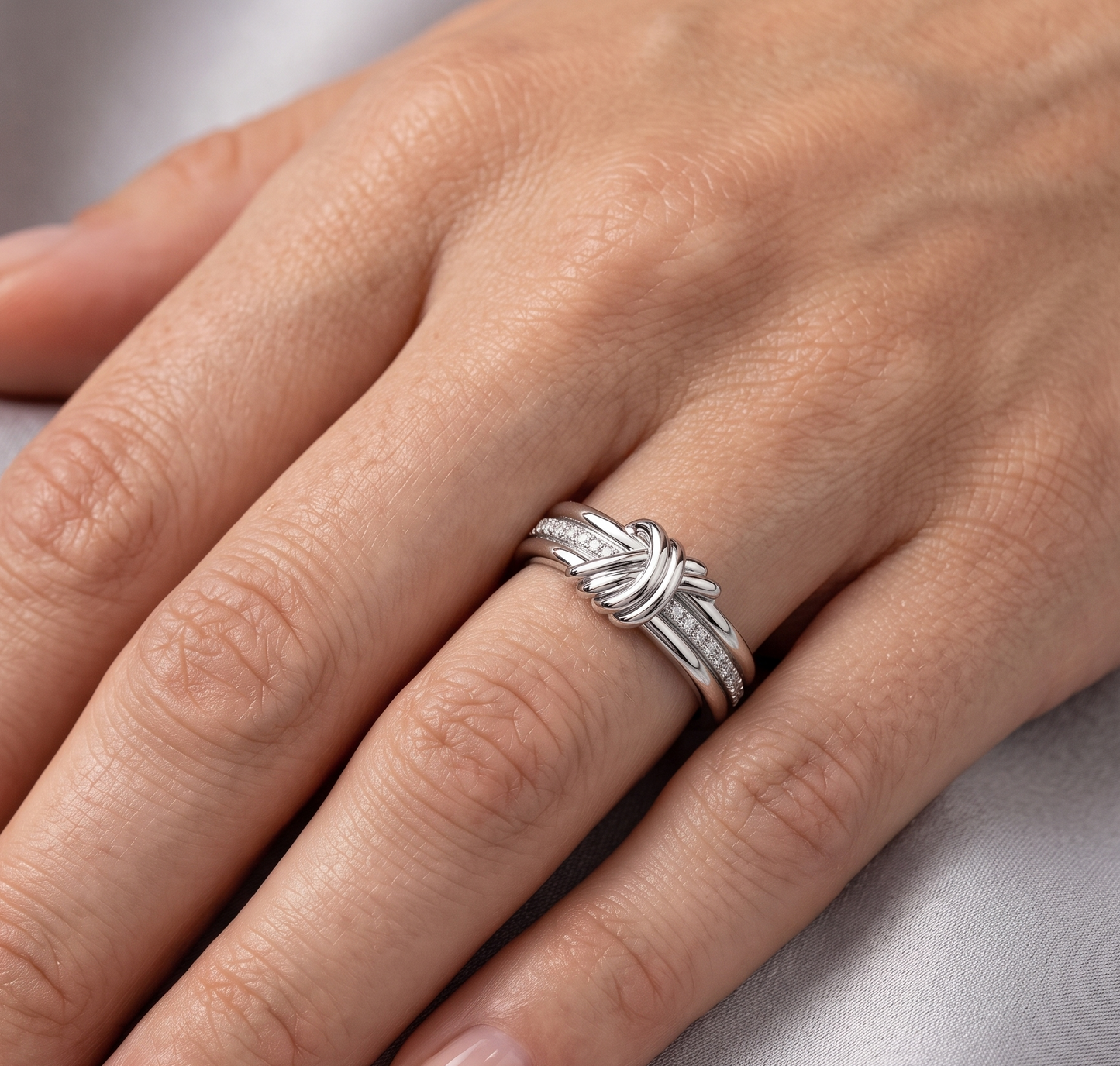 A silver-toned triple-band ring