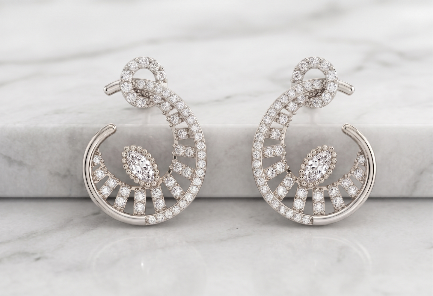 A pair of silver-toned crescent-shaped hoop earrings