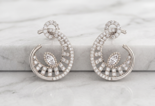 A pair of silver-toned crescent-shaped hoop earrings
