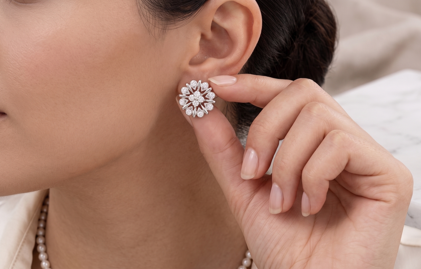 A pair of silver-toned flower-shaped stud earrings