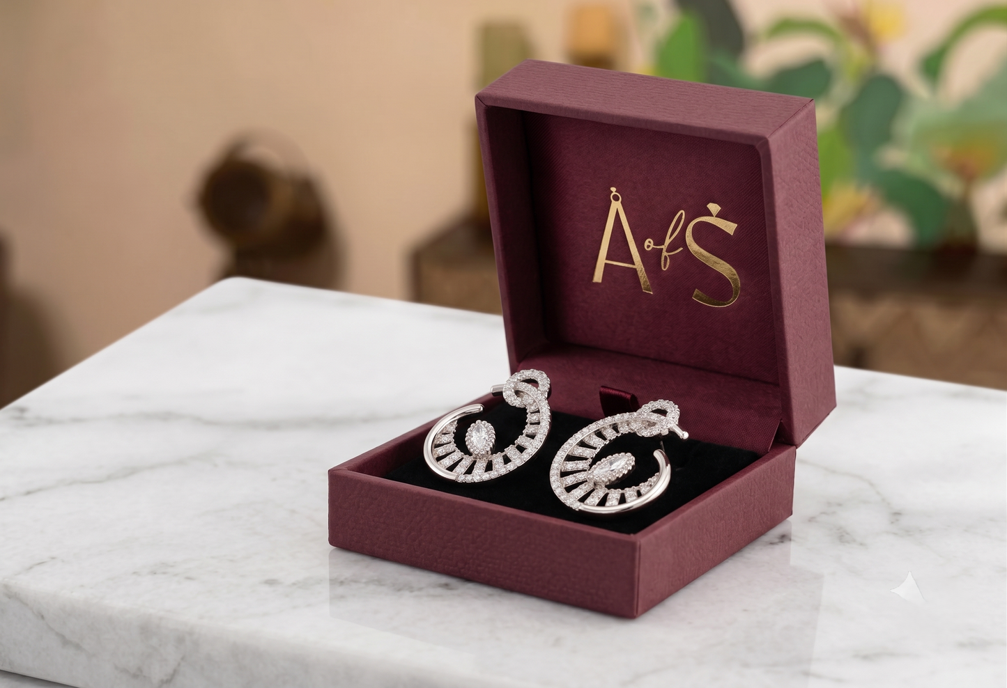 A pair of silver-toned crescent-shaped hoop earrings