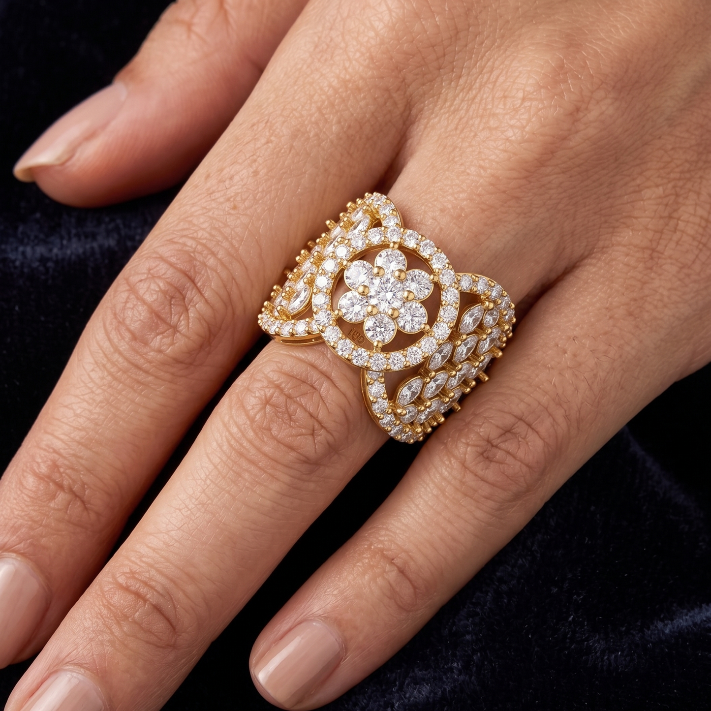 A wide yellow gold plated ring featuring