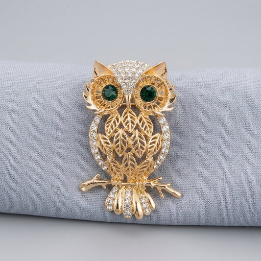 The owl men brooch with green gemstone in gold plated