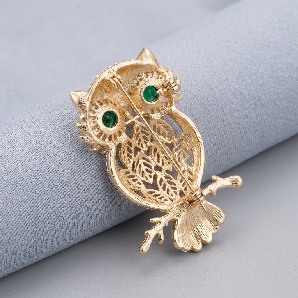 The owl men brooch with green gemstone in gold plated