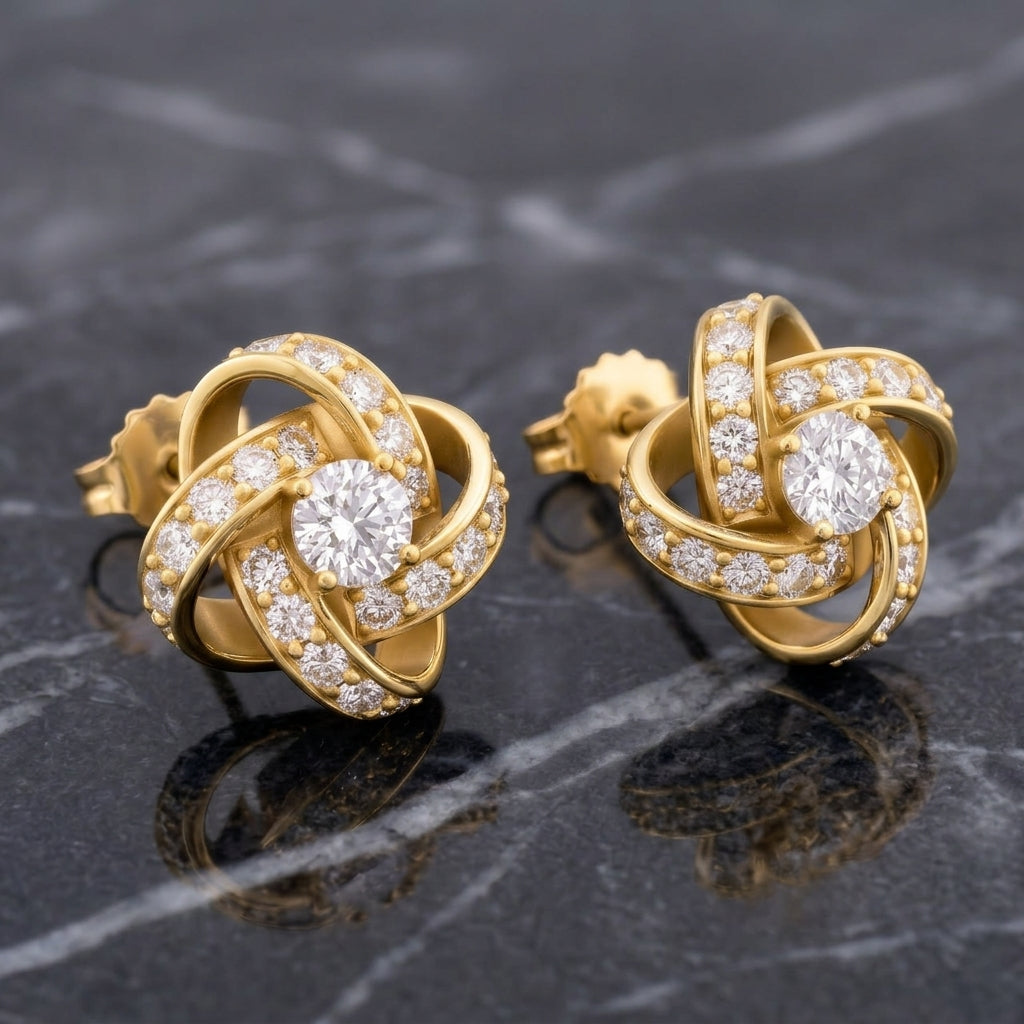 The pair of silver-toned knot stud earrings